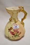 An early 20th century Royal Worcester blush ivory hand decorated ewer having a hand painted flower