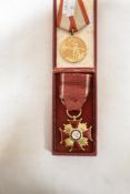 Two yellow metal medals one marked PRL and a similar Russian sports medal dated 1941-1945