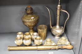 A selection of metal wares including brass ink wells, Turkish style ewer, impressed brass lamp and