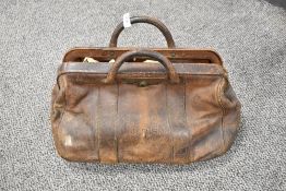 An antique leather Gladstone bag in fair condition