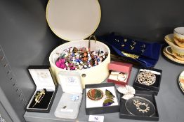 A selection of modern costume jewellery including yellow metal necklaces, enamel brooches and