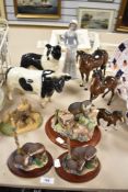 Three Beswick horses with damage, a Coopercraft cow and dog and three Border Fine Arts Otter