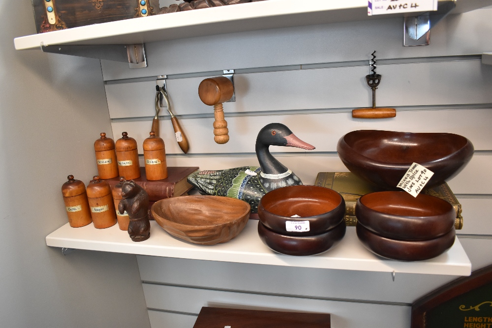 A selection of treen wood kitchen wares including spice jars, bowls, corkscrew and a bear form nut