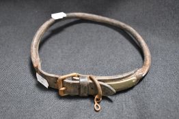 An early 20th century leather dog collar with metal fitments and unmarked name badge