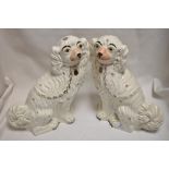 A pair of Victorian Staffordshire flat back Spaniel dogs in white glaze.