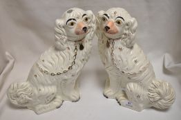 A pair of Victorian Staffordshire flat back Spaniel dogs in white glaze.
