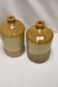 Two antique salt glazed advertising flagons for G W Ealand wine merchant and Plato Harrison Fleece