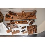 A selection of early 20th century joinery planes and wood working tools including jack plane,