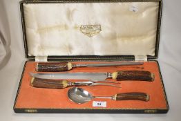 An early 20th century Lewis Rose carving knife set with horn handles.