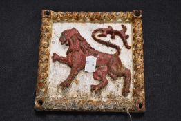 A Victorian cast iron wall plaque possibly for insurance with gryphon style motif