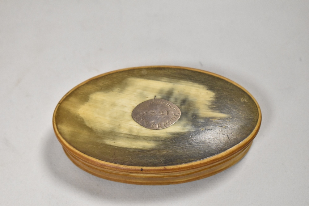 An early Victorian snuff box in carved horn with a silver plaque dated 1821 Liverpool.