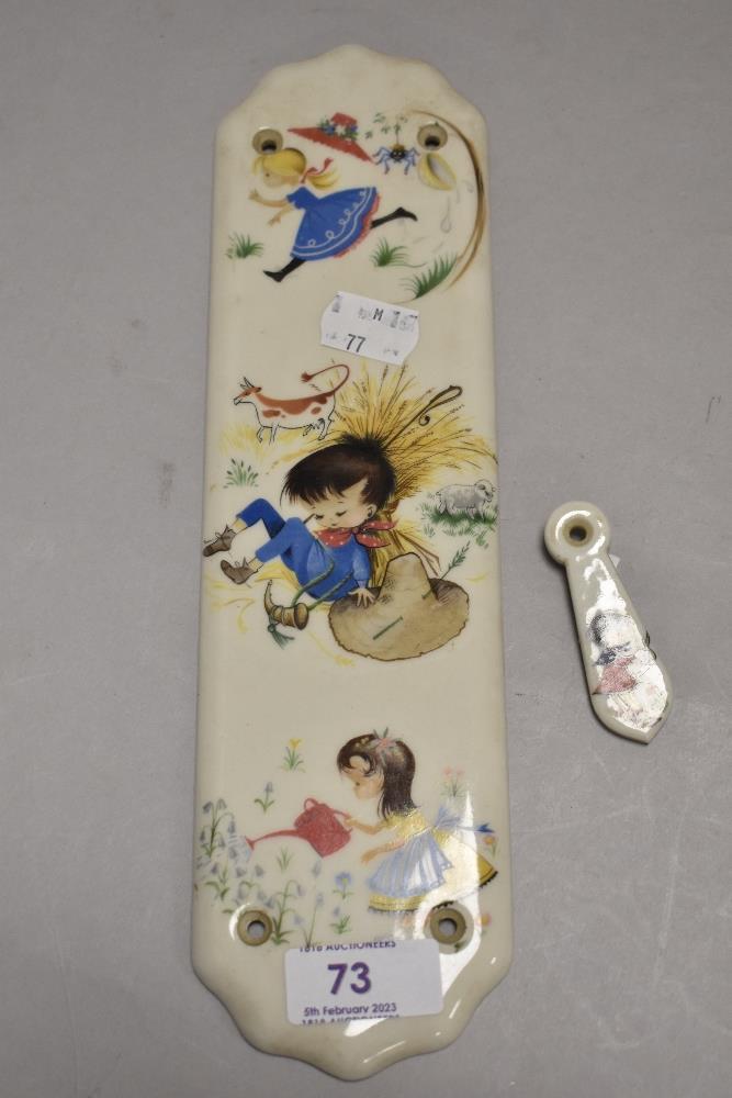 A mid century door finger plate and escutcheon with kitsch cartoon design
