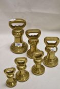 A fine set of graduated brass kitchen weights