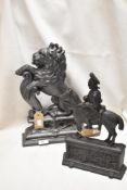 Two Victorian cast iron door stops one in the form of a rampant lion and the other as a military