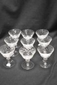 A set of nine clear cut crystal glass cocktail glasses having a cut design