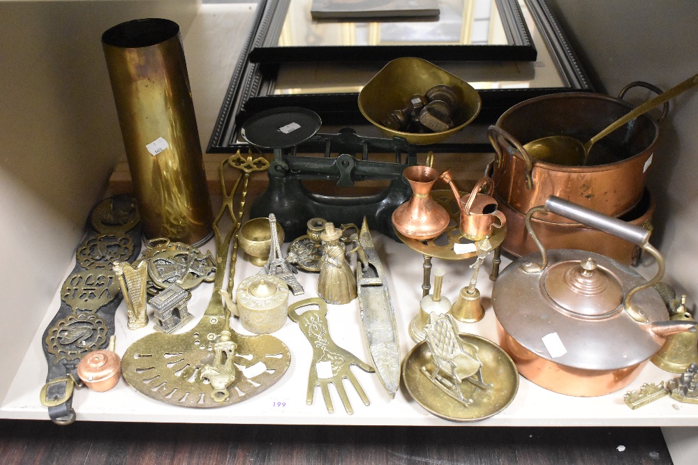 A selection of metal hardware items including balance scales with weight set, copper cooking pots,