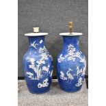 A pair of antique Qing dynasty mirrored floor vase having a reverse blue and white embossed