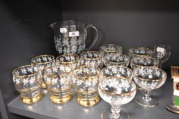 A 1950's cocktail or lemonade jug and glass set with gold trim and etched oak leaf design