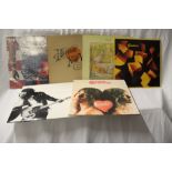 A mixed lot of twelve albums from Neil Young, SAHB. Springsteen, Genesis, Heart and Queen