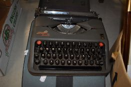 Two vintage cased typewriters. An Empire Aristocrat and an Olivetti Lettera 32.