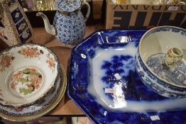 An assortment of vintage and antique ceramics, blue and white platters, fruit bowls, tea pot with