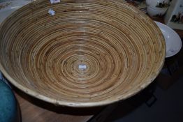 A large modern rattan bowl, of circular form constructed by traditional techniques.