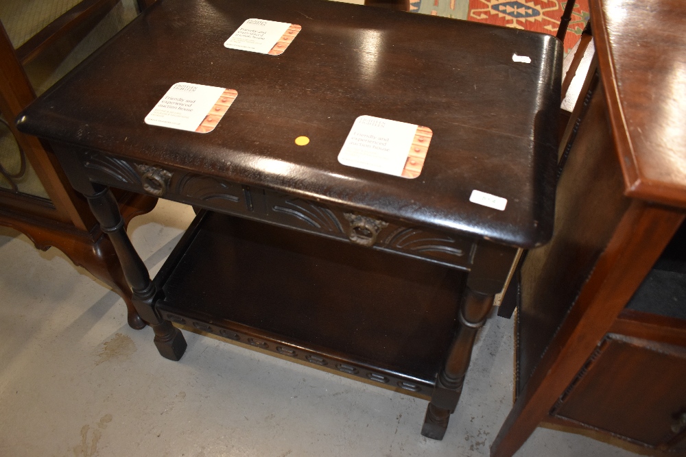 A mid to late 20th Century dark stained frame side table in the Priory style