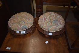A pair of 19th Century mahogany footstools having later upholstery