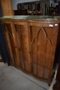 An early 20t Century walnut china cabinet