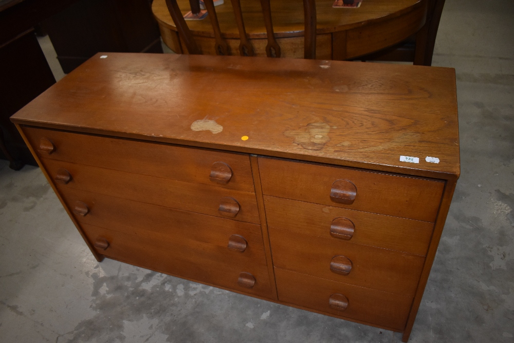 A vintage teak chest of four long beside four short drawers having stylised handles, width approx.