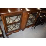 An Edwardian mahogany low display cabinet on cabriole legs
