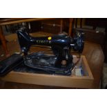 A vintage Singer 99K electric sewing machine having wooden base (no lid)