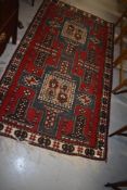 A Persian style rug having deep vibrant red ground, approx. 184 x 104cm