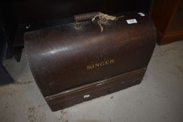 A vintage Singer sewing machine in dome top case
