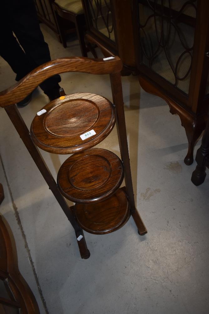 An early 20th Century oak folding cake stand