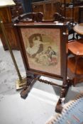 A 19th Century Rosewood framed oversized firescreen having tapestry inset