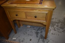 A modern golden oak hall table having two deep drawers