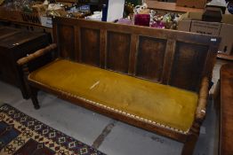 A period oak settle having panel back with carved monogram and date, RDL 1843 and turned arms and