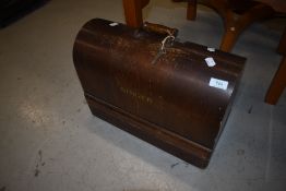 A vintage Singer sewing machine in dome top case