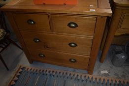 A modern stained chest of two over two drawers