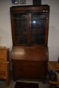 A late 19th or early 20th Century oak bureau bookcase having leaded glass top section and three