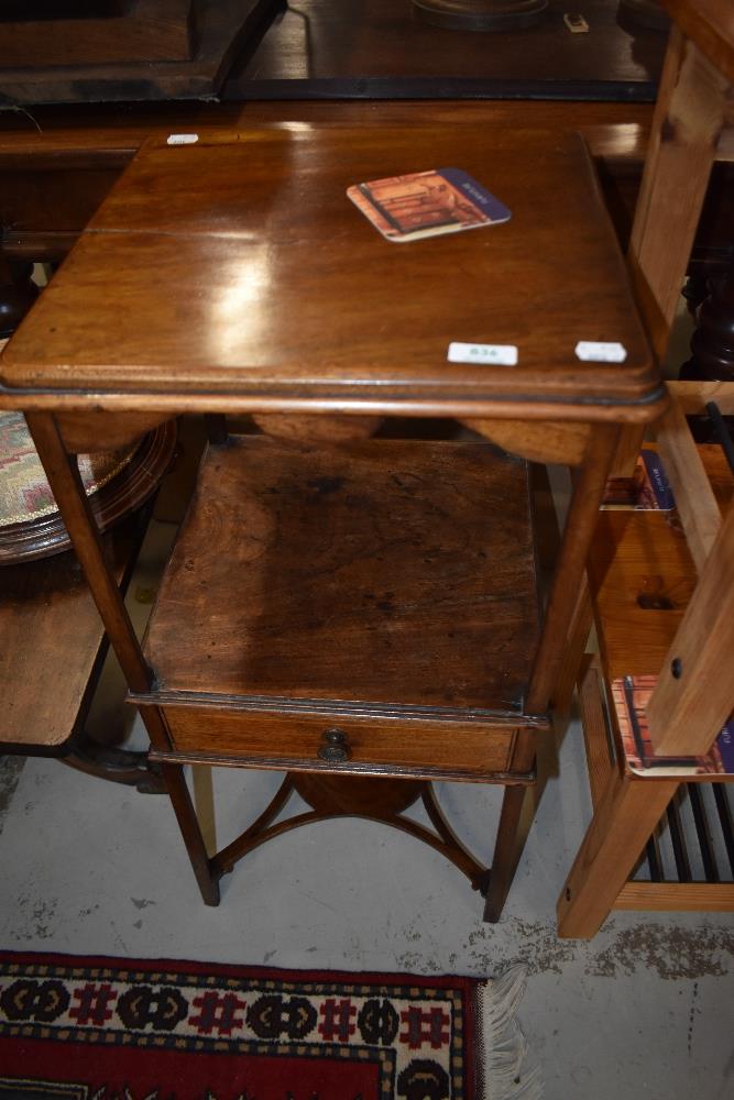 A 19th Century mahogany plant stand having central drawer with line inlay decoration