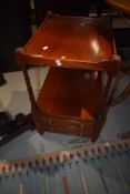 A reproduction Regency mahogany etage style side table with double drawers to base