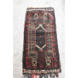 A vintage saddlebag rug, having traditional pattern.