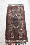 A vintage saddlebag rug, having traditional pattern.