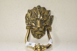 A large cast brass lion mask door knocker.