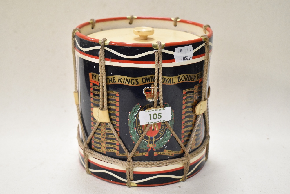 A 1970s ice bucket in the form of a drum, having Kings Own Royal Border Reg dates and motif