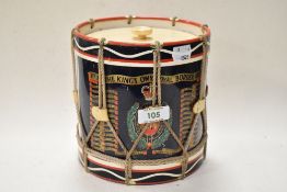 A 1970s ice bucket in the form of a drum, having Kings Own Royal Border Reg dates and motif