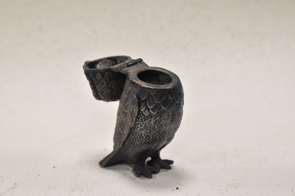 A cast metal owl having hinged head and glass eyes. - Image 2 of 3