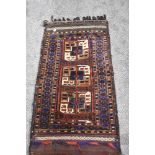 A vintage saddlebag rug, having traditional pattern in red, blue, green, brown and cream.